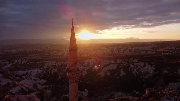 Aerial Landscape of Air Balloon Flying Beside Mosque Tower Against Amazing Sunset