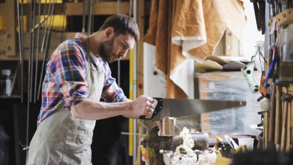 Carpenter Working With Saw And Wood At Workshop 8