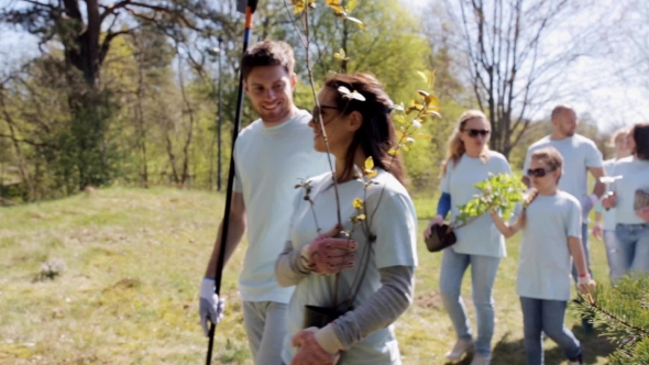 Group Of Volunteers With Trees And Rake In Park 24