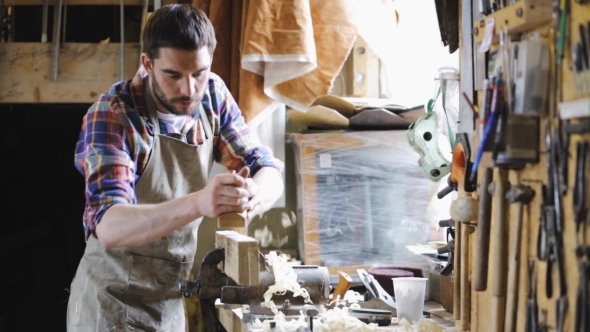 Carpenter Working With Plane And Wood At Workshop 1