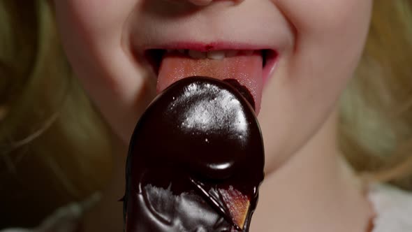 Playful Teen Child Kid Girl Eating Licking Melted Chocolate Sweet Candy Syrup From Wooden Spoon