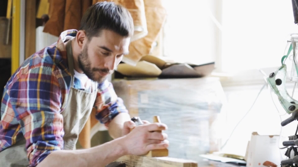 Carpenter Working With Plane And Wood At Workshop 2