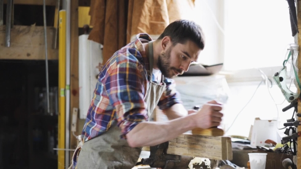 Carpenter Working With Plane And Wood At Workshop 4