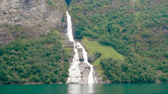 With The High Cliffs Of The Norwegian Fjords Falls Waterfall