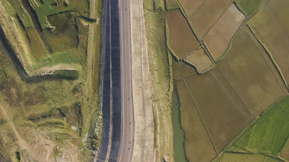 Aerial view of a road among the fields in Sapahar, Rajshahi, Bangladesh.