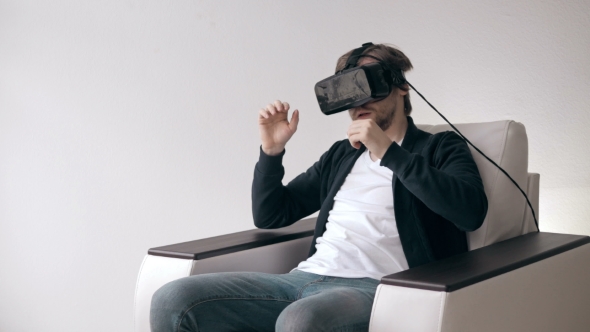 Man Wearing Virtual Reality Glasses Watching Movies Or Playing Video Games.  VR Headset Technology