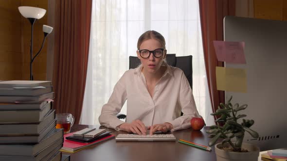 Beautiful Young Woman in White Shirt at Home Desktop, Searching Internet, Showing Hands a Stop 