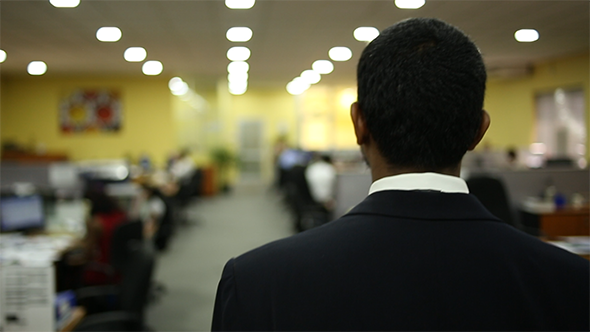 Asian Man Walking Through Office