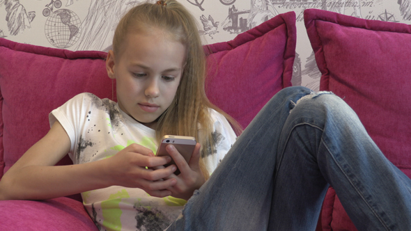 Young Girl Using Smartphone At Home 10