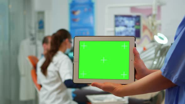 Dentist Nurse Holding Tablet with Greenscreen Display