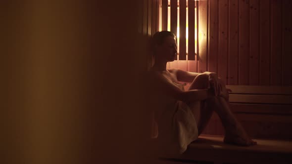 Young woman relaxing in the sauna