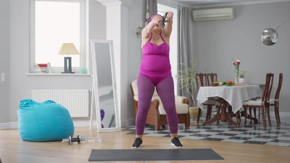 Wide Shot of Hilarious Obese Woman Grimacing Stretching Resistance Band Training at Home