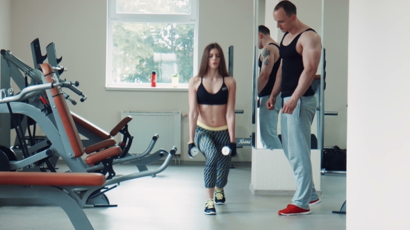 Coach Helping Woman Doing Lunges Exercise Right