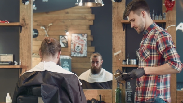 Barber Spraying Razor With Perfume And Fire