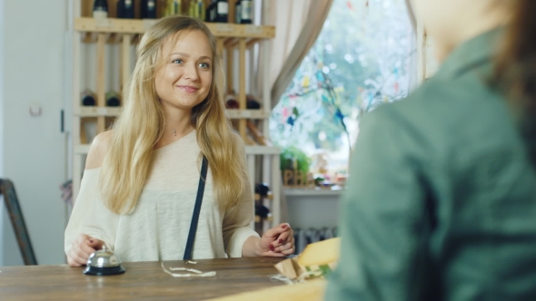 Attractive Woman Buying Something In a Store To Pay For Goods In Cash.