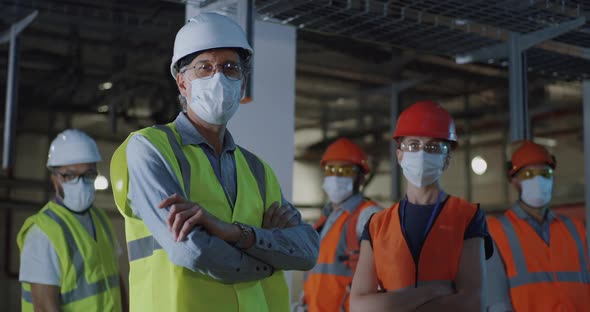 Confident Engineers in Masks on Power Stations