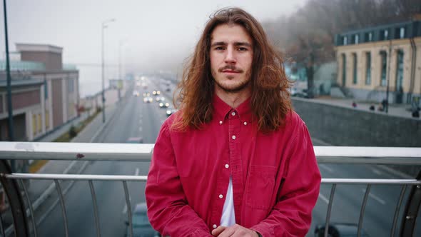 Close Up Portrait of a Young Modern Skater with Long Hair and a Red Shirt