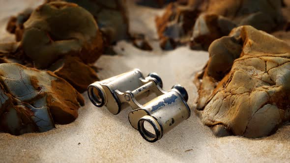 Old German Military Binoculars on the Sand Beach alt