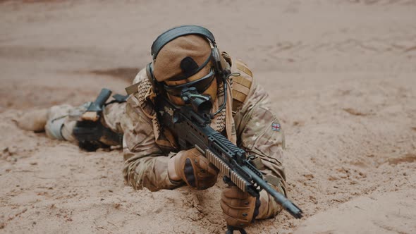 Focused Soldier at Ground Level Stance Aiming Using Target Scoop