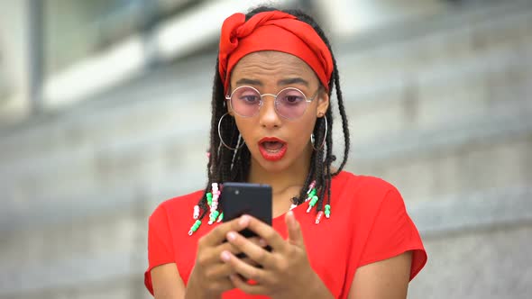 Attractive African American Girl Surprised Reading About Sales and Discounts