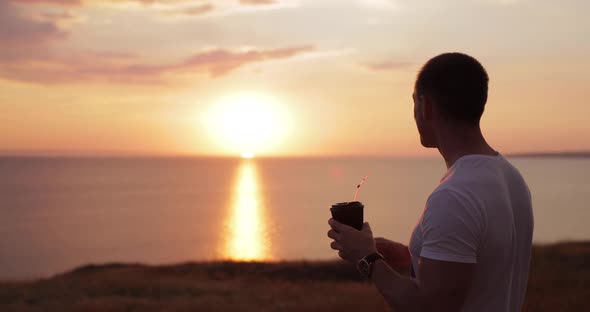 Man Drinking Takeaway Cocoa at the Nature