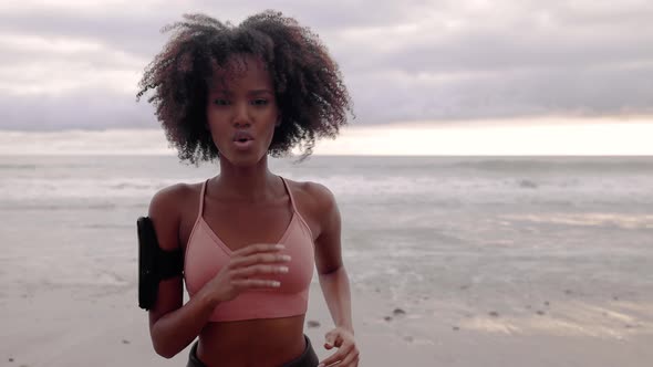 Slow motion shot of an Somali woman jogging on the beach