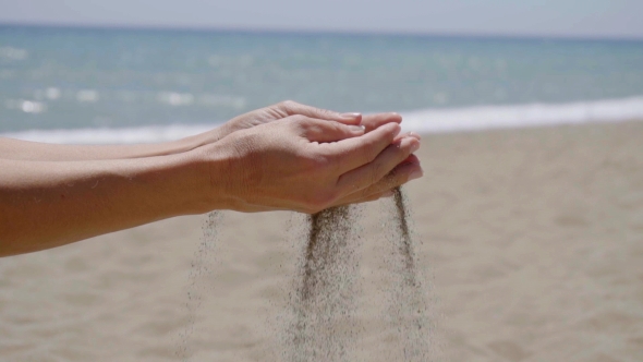 Stream Of Sand Pouring From Hands