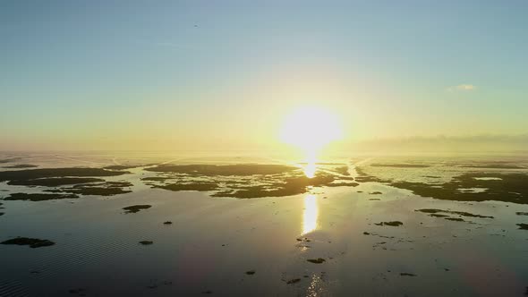 Aerial view Beautiful view sunset or sunrise over water surface beautiful wave Amazing light twiligh