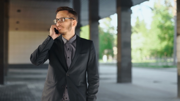 Portrait Of Young Successful Business Man Having Cell Telephone