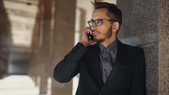 Portrait Of Young Successful Business Man Having Cell Telephone