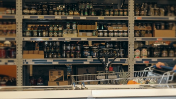 Handsome Man Shopping In A Supermarket, Taking Frozen Food From Freezer