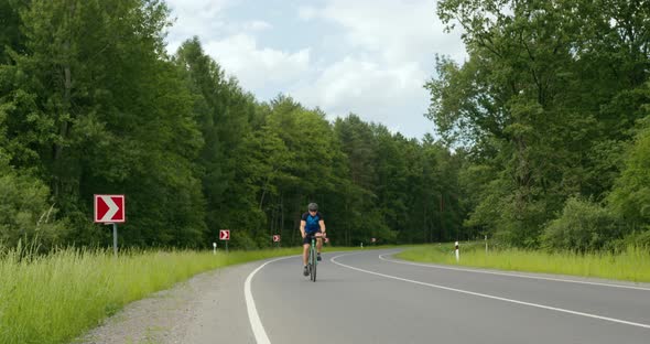 A Cyclist is Riding on the Road