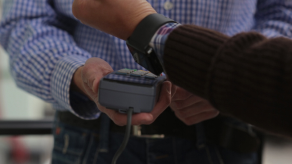 Man is Paying with a Smart Watch