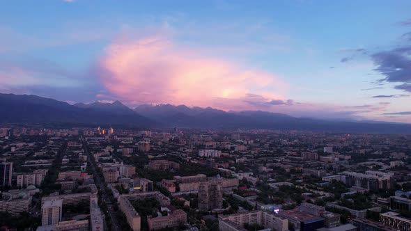 Pink and White Sunset and Clouds Over Mountains