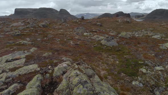 Hardangervidda mountain plateau valley, Norway, aerial reveal