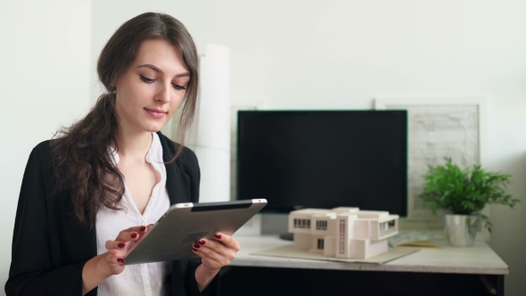 Woman Holding a Tablet With App Mobile Wallet. House or Home Model