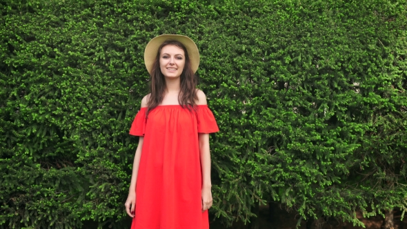 Beautiful Happy Model Standing Playful In Red Dress On Nature