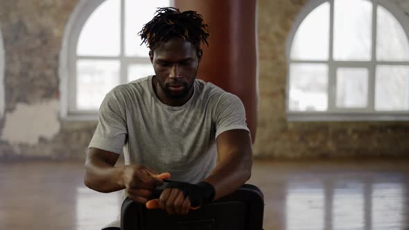 Afro American Boxer is Wrapping Hands with Black Bandage