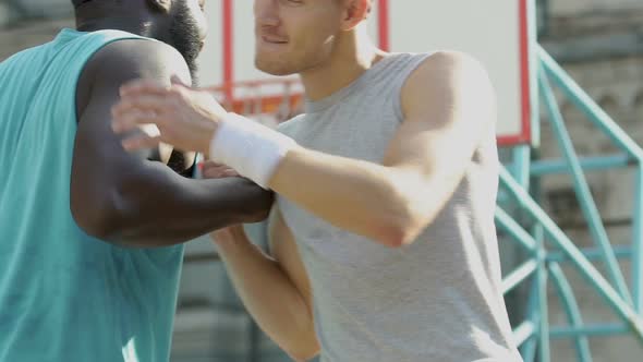 Two Friends Greeting Each Other Making Cool Handshake Before Basketball Game