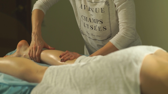 Woman Lies On a Massage Calf