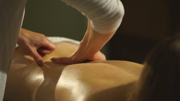 Woman Getting a Back Massage Hands