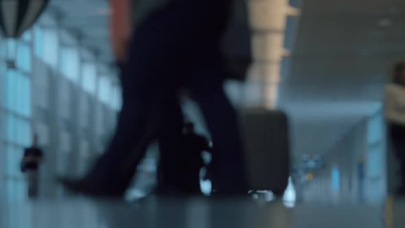 People with luggage in airport hall, defocus