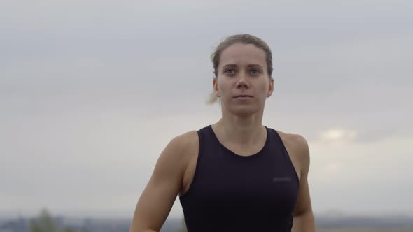 Caucasian Woman is Doing Morning Jog Outdoors to Maintain Health Front View