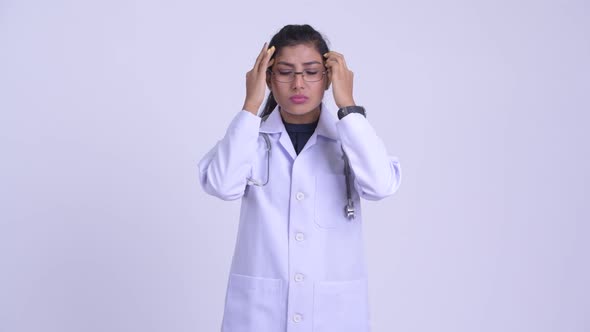 Young Stressed Persian Woman Doctor Having Headache
