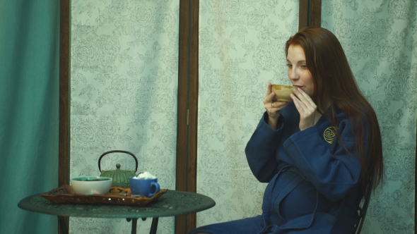 Young Pregnant Woman Drinking Tea After The Massage
