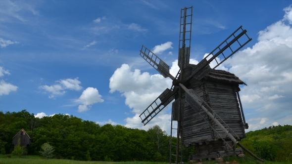 Old Windmill And Floating Clouds