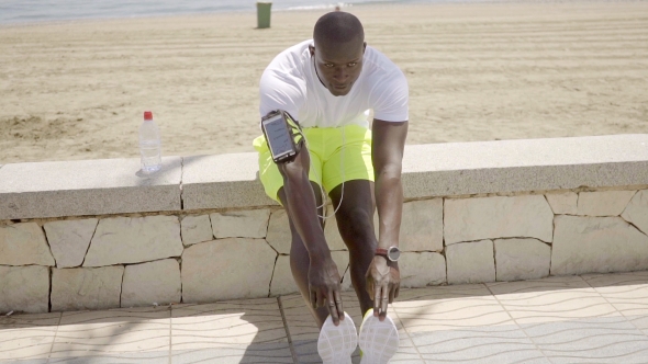 Muscular African Man Doing Stretching Exercises