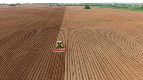 Farmer Seeding, Sowing Crops At field.Aerial View.