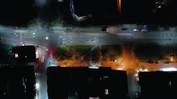 Bird's Eye View of a Town on a Friday Night with Cars and Revellers 