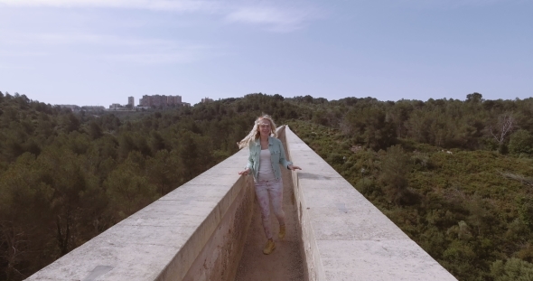 Tourist Girl Walk Thru The Ancient Devil's Aqueduct